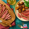 Ein kA?stliches Gericht mit geschnittenem Steak, Bratkartoffeln und grA?nen Bohnen, gewA?rzt mit McCormick-GewA?rzen.