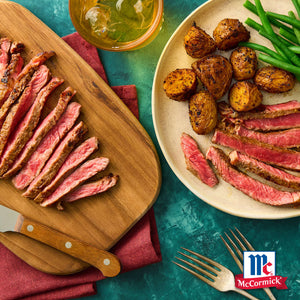 Ein kA?stliches Gericht mit geschnittenem Steak, Bratkartoffeln und grA?nen Bohnen, gewA?rzt mit McCormick-GewA?rzen.
