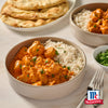 Eine Schüssel cremiges Chicken Tikka Masala serviert mit Basmatireis und frischem Koriander mit dem McCormick-Logo und Srpet Curry X06-Ge.
